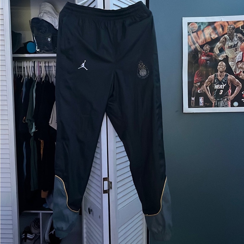 Jordan Joggers, color black with yellow detailing, it is a size small.